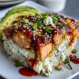 Hot and bubbly Spicy Salmon Sushi Bake casserole featuring golden melted mozzarella cheese and seasoned sushi rice layered with spicy salmon.