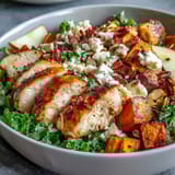 This hearty Fall Sweet Potato Harvest Bowl features sliced chicken, toasted almonds, and a balsamic vinaigrette drizzle over fresh greens.  