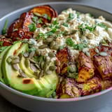 Golden roasted sweet potato cubes, creamy avocado slices, and a dollop of cottage cheese in a Hot Honey Sweet Potato Bowl.