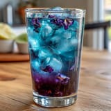 Refreshing color-changing lemonade made with butterfly pea flowers, perfect for summer parties and impressing guests with its vibrant transformation.