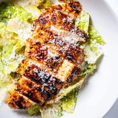 Juicy grilled chicken, crisp romaine, and creamy Caesar dressing on a toasted bun for a satisfying Caesar Chicken Sandwich.
