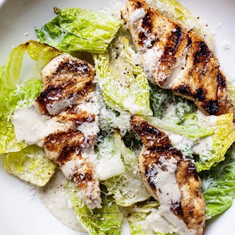Golden brioche buns hold tender garlic grilled chicken, fresh romaine, and Parmesan in this classic Caesar Chicken Sandwich.