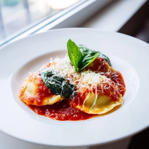 Perfectly sealed ravioli filled with creamy ricotta and spinach, served hot with rich marinara sauce.