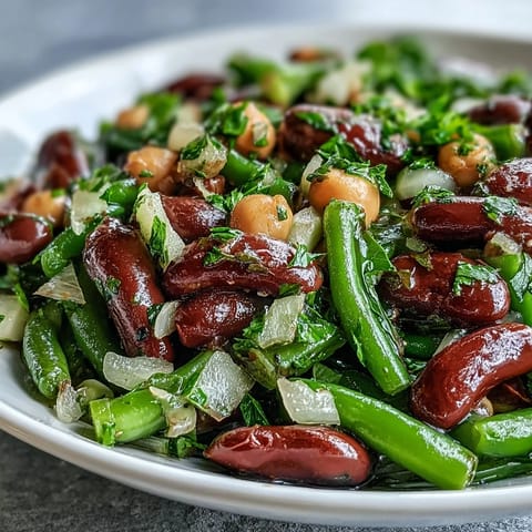 Tangy, refreshing Three-Bean Salad ready to be served as a healthy potluck side.