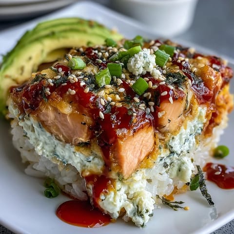 Hot and bubbly Spicy Salmon Sushi Bake casserole featuring golden melted mozzarella cheese and seasoned sushi rice layered with spicy salmon.