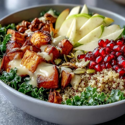 Freshly roasted sweet potato cubes and massaged kale fill this vibrant Kale Harvest Grain Bowl, topped with pomegranate seeds and pepitas.