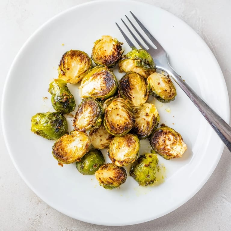 Whole roasted Brussels sprouts with caramelized bits, served as a vegetarian side dish for dinner.