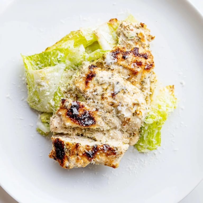 A hearty Caesar Chicken Sandwich layered with creamy Caesar dressing, chopped romaine, and succulent grilled chicken, perfect for lunch.