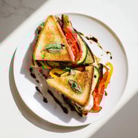 Golden, crispy sourdough slices sandwich roasted zucchini, peppers, melted mozzarella, tomato, and basil in this Roasted Veggie Caprese Grilled Cheese.  
